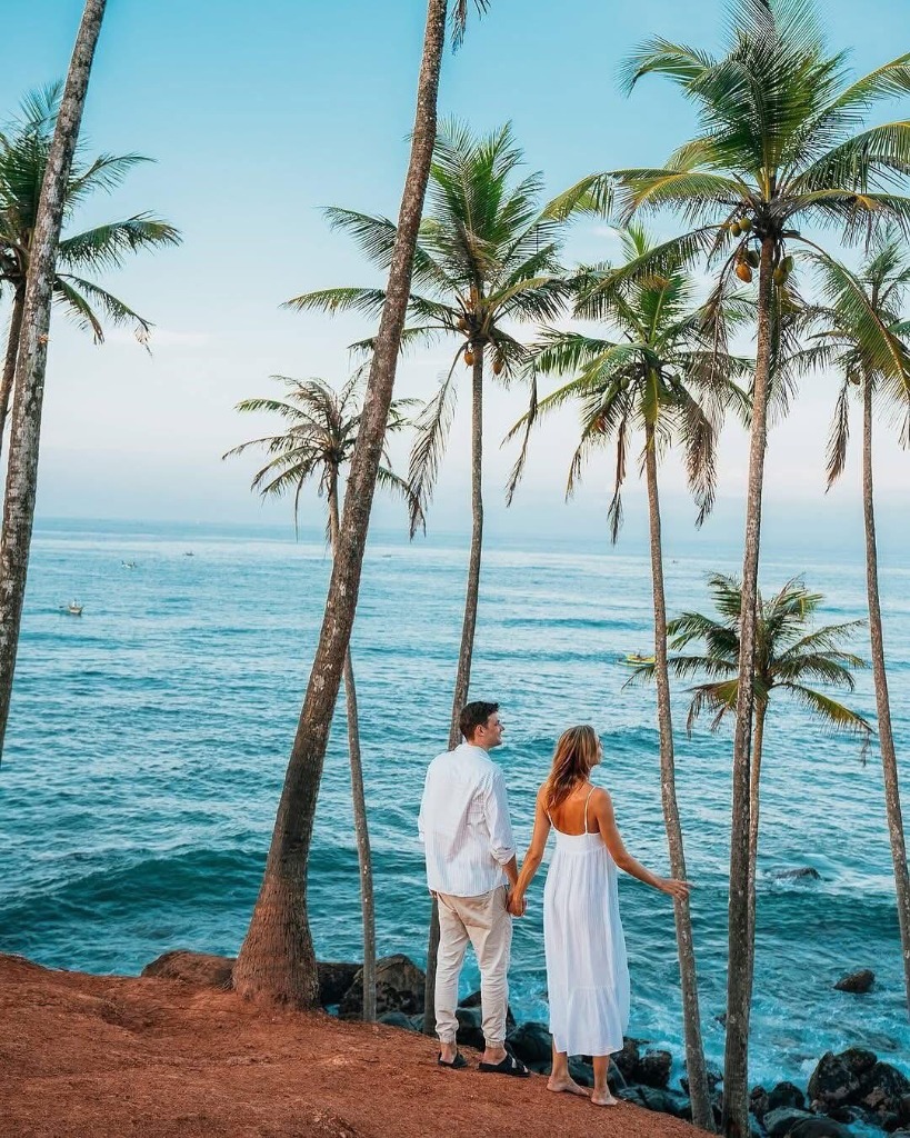Couple Under Palms by the Ocean